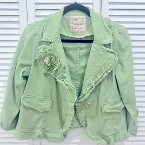Cropped green jacket with flower detail.